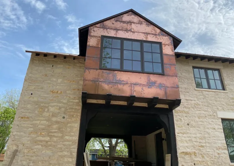 Copper metal panel facade on a stone building for Skylight Installation in Cedar Grove